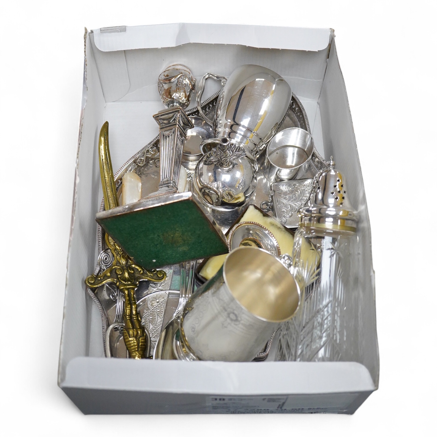 A silver plated etched cup, silver plated cup, a silver plated candlestick, two silver napkin rings, a cut glass sugar shaker and a silver paperweight & eight other items.